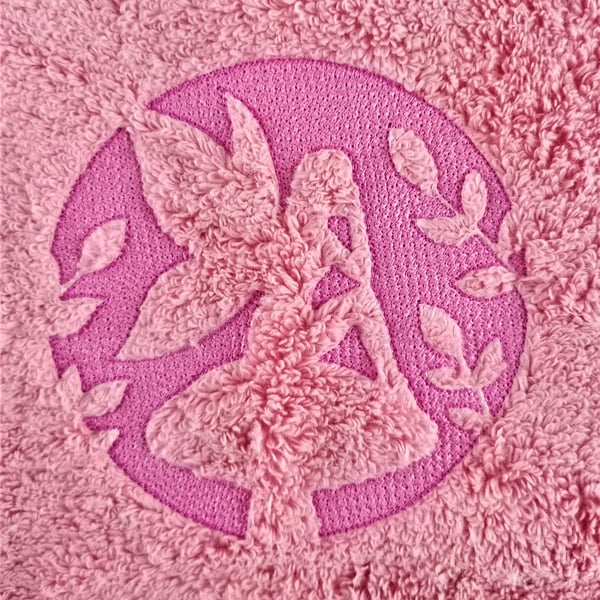 Fairy Dreaming sat on a toadstool embossed on a pink hand towel